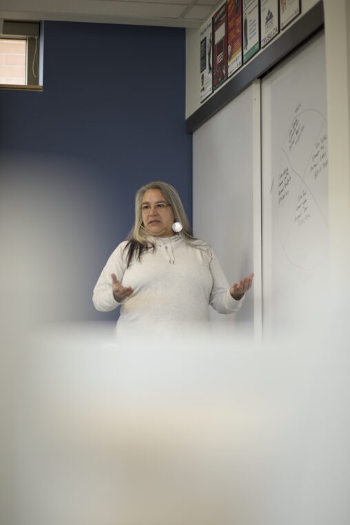 Indigenous teacher from the Fort McKay First Nation teaching Indigenous culture using a whiteboard.