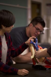 Indigenous students from the Haida and Ntekepmx Nations examining a heart model.