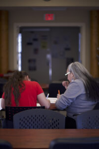 Two indigenous students from the St'at'imc/Nlaka'pamux and Fort McKay First Nations sitting and studying in a common space on campus.